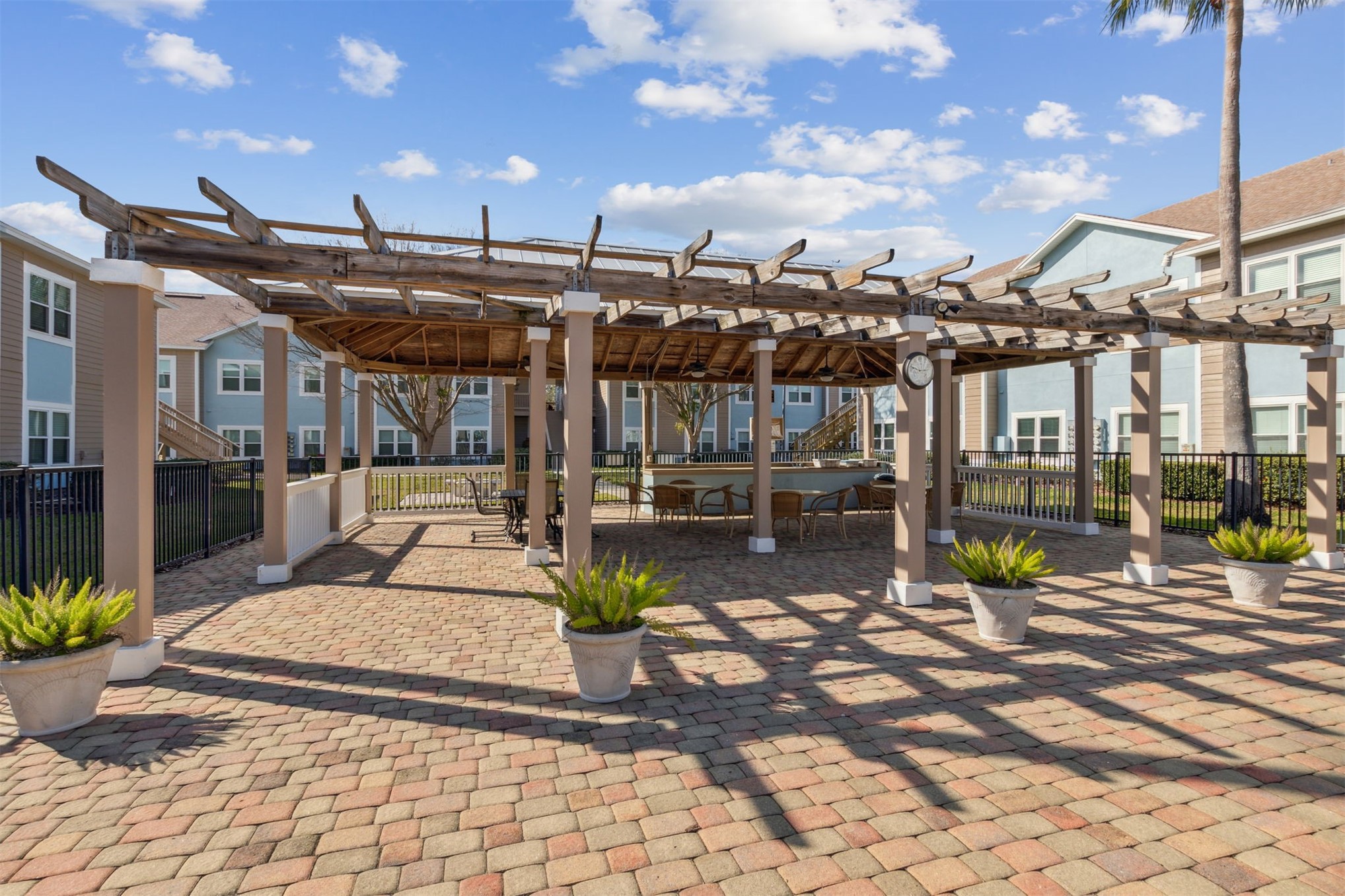 1601 Nectarine Street, Unit A6 Fernandina Beach, FL 32034 - Photo 32 of 40 a view of a patio with table and chairs a barbeque with plants and palm trees