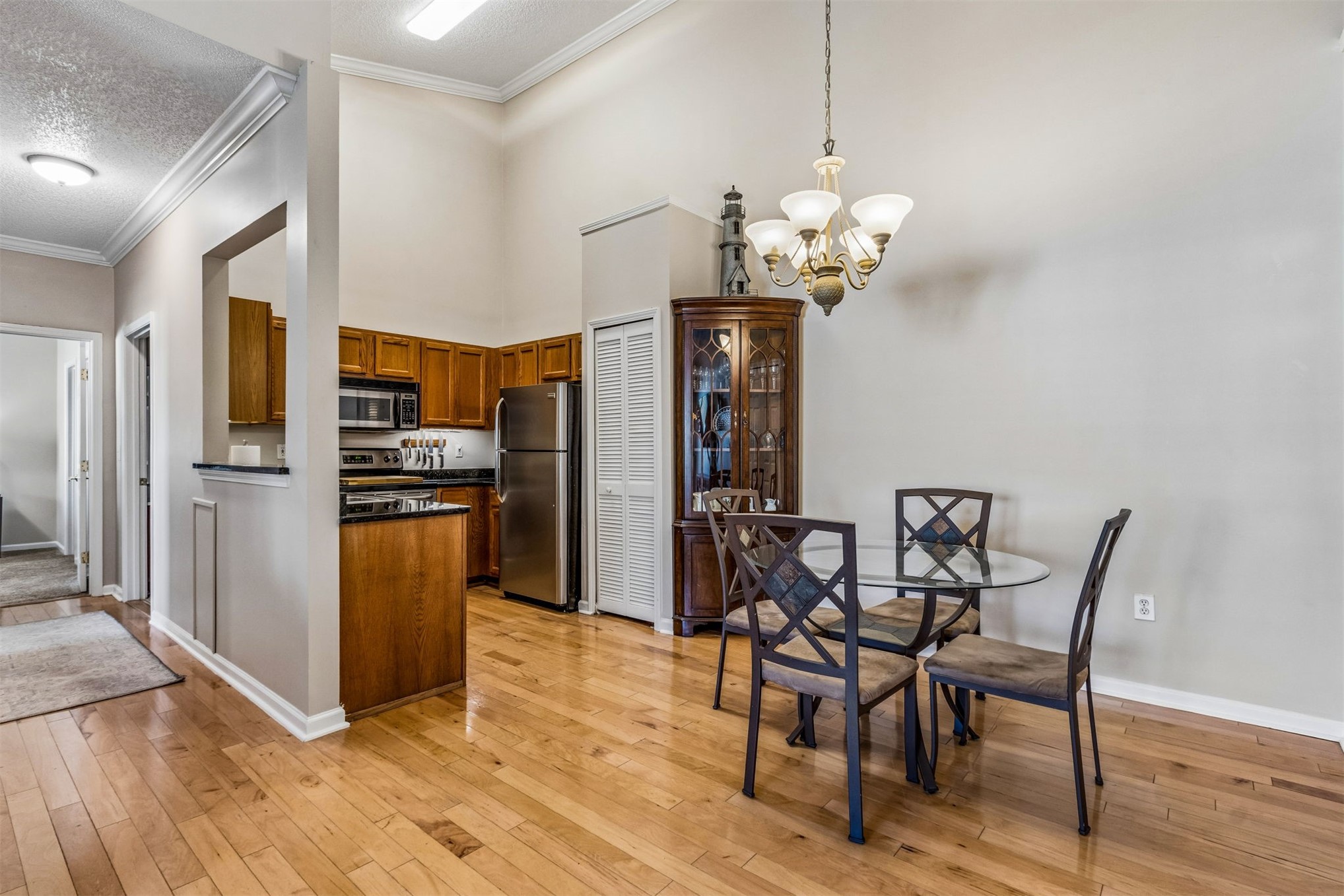1601 Nectarine Street, Unit A6 Fernandina Beach, FL 32034 - Photo 10 of 40 a view of a dining room with furniture a chandelier and wooden floor