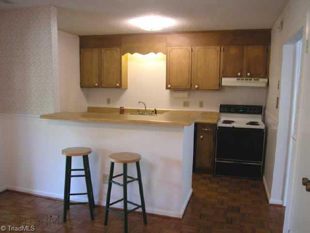5741 Bramblegate Road, Unit A Greensboro, NC 27409 - Photo 5 of 9 Other. Kitchen Area - Freshly painted in neutral colors. Breakfast bar.