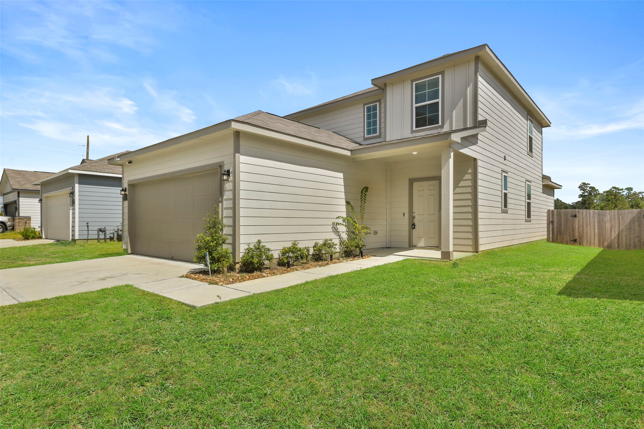 20811 Adventure Way Porter, TX 77365 - Photo 1 of 28 a front view of a house with a yard and garage