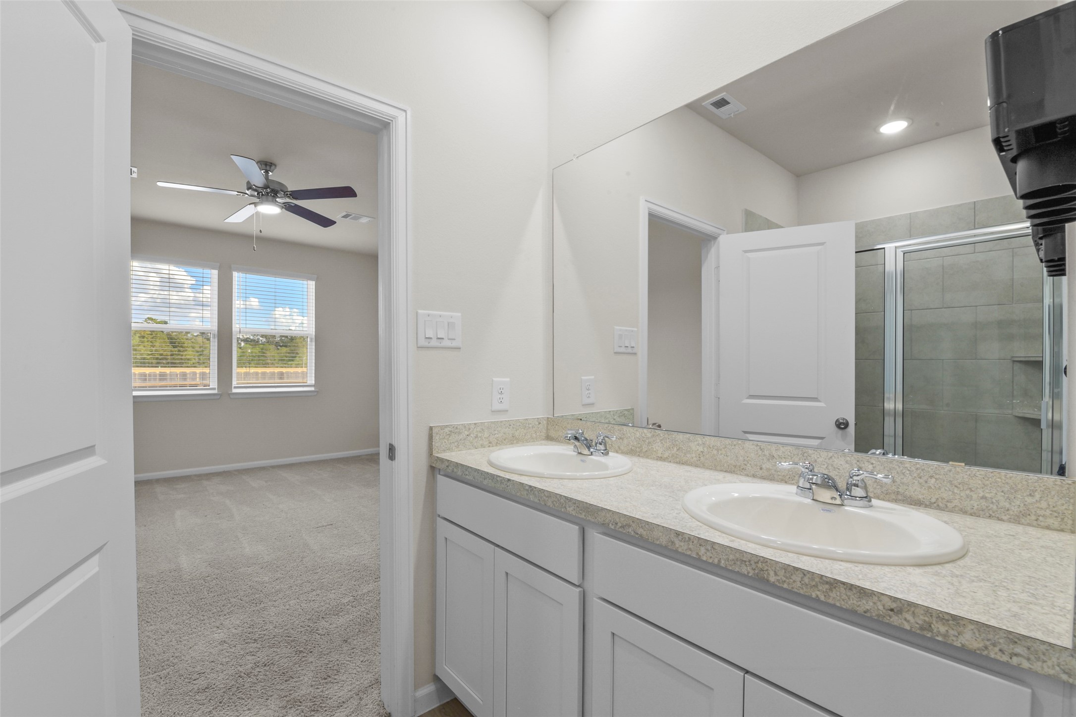20811 Adventure Way Porter, TX 77365 - Photo 24 of 28 a bathroom with a double vanity sink a mirror and a light fixture