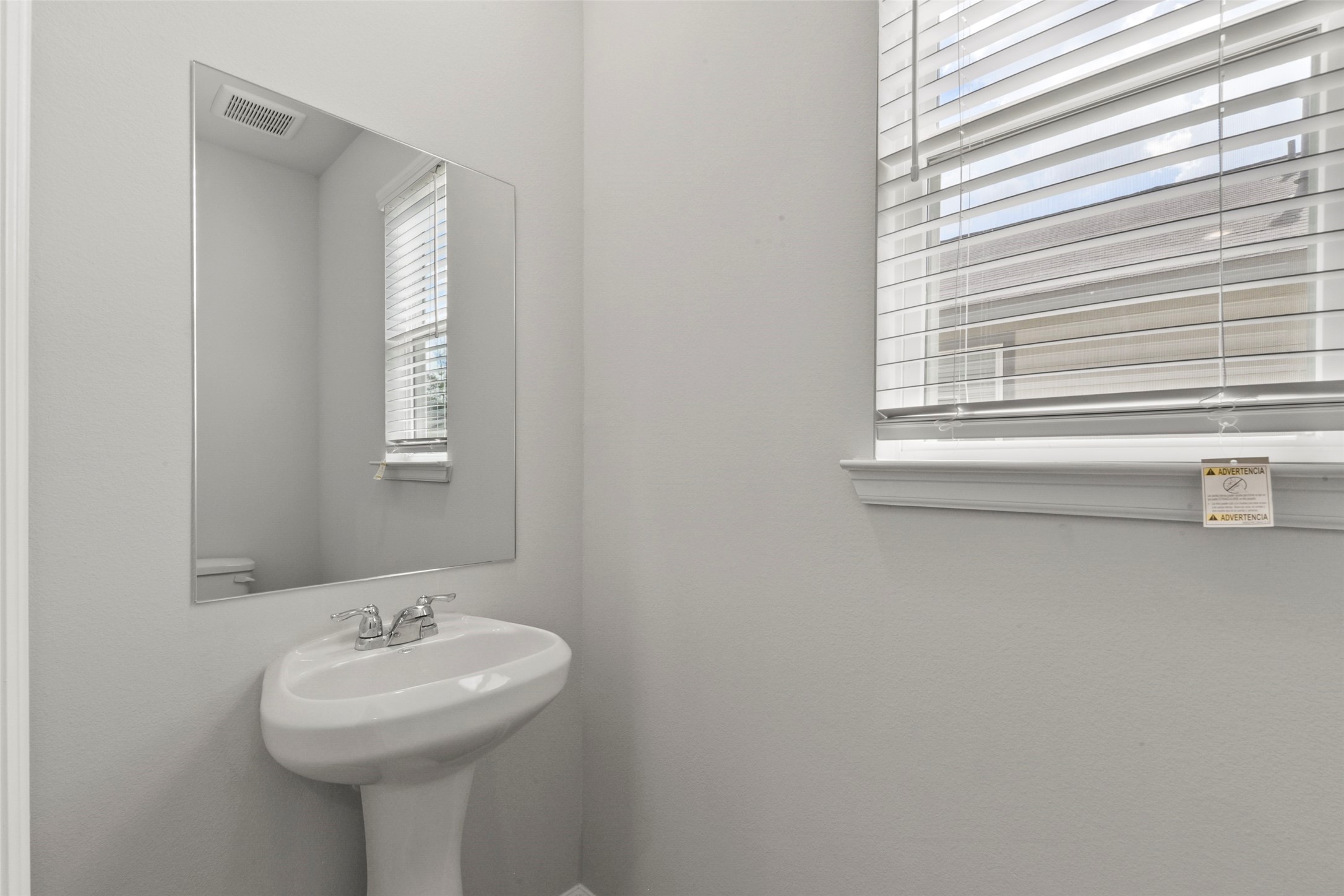 20811 Adventure Way Porter, TX 77365 - Photo 25 of 28 a bathroom with a sink a mirror and a window