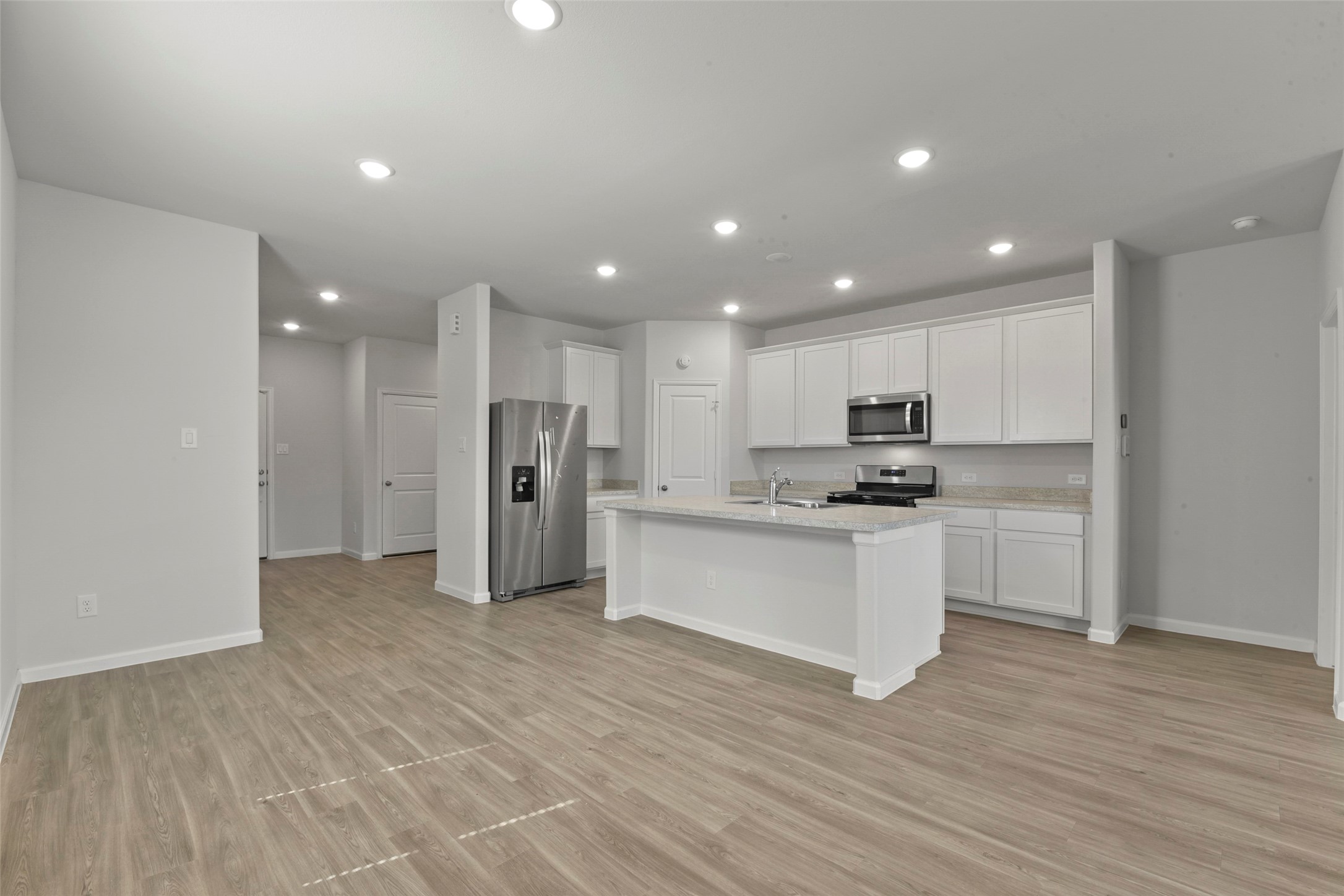 20811 Adventure Way Porter, TX 77365 - Photo 6 of 28 a kitchen with stainless steel appliances refrigerator sink and microwave