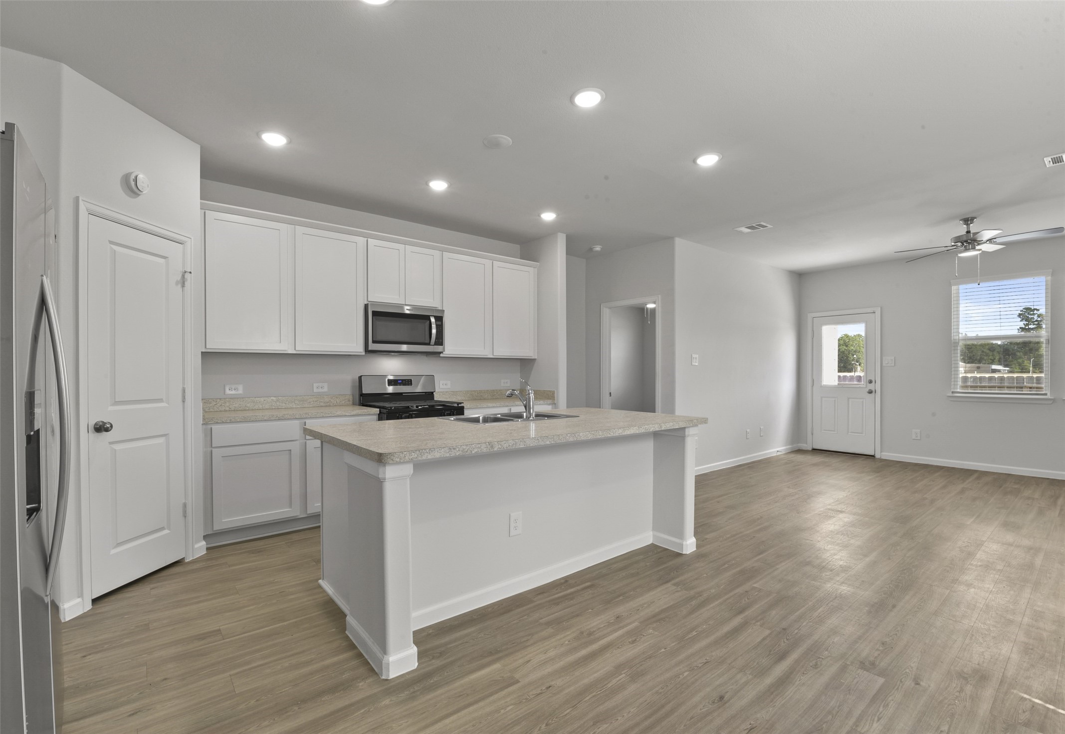20811 Adventure Way Porter, TX 77365 - Photo 8 of 28 a kitchen with stainless steel appliances granite countertop a stove a sink and white cabinets