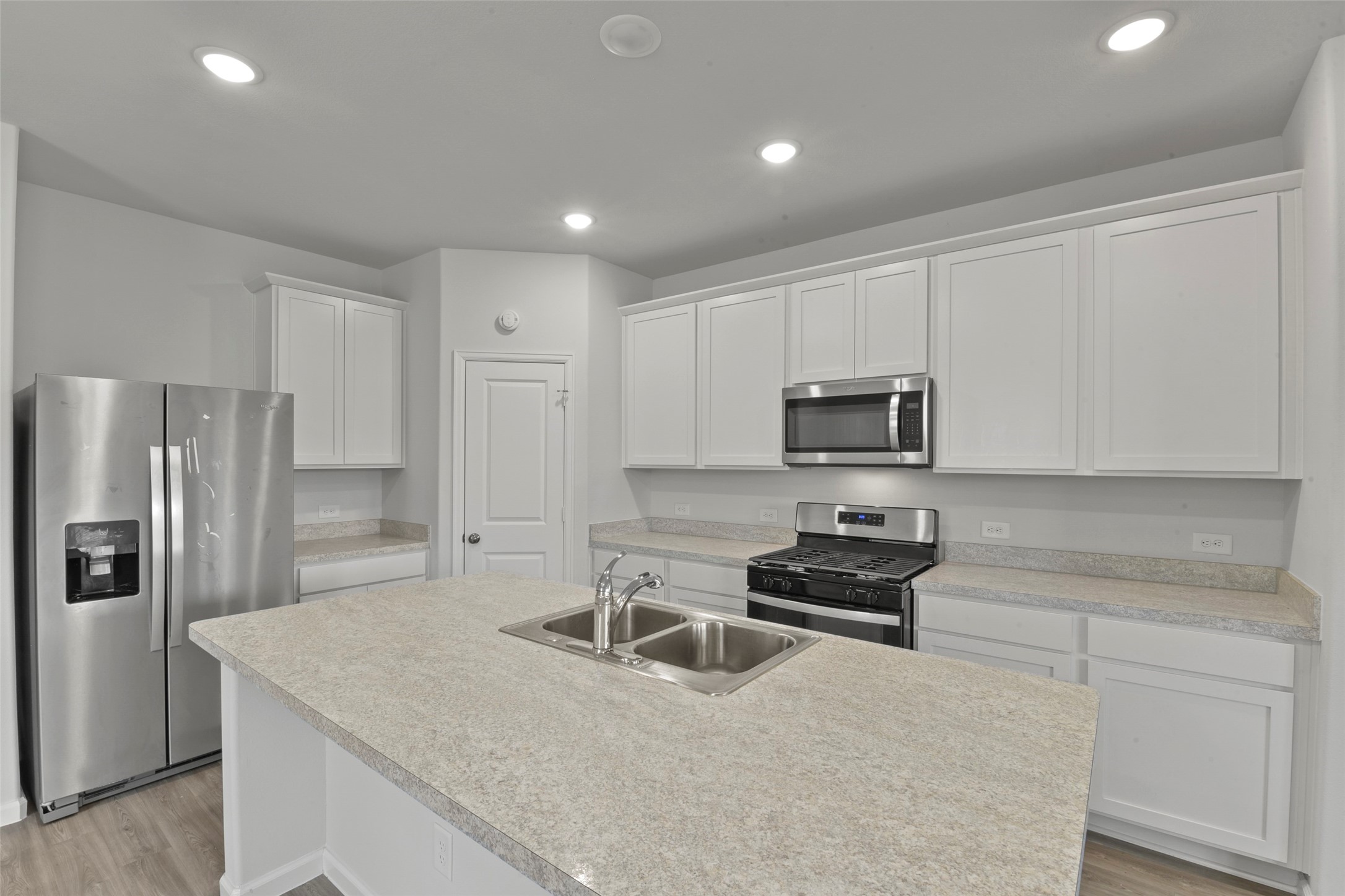 20811 Adventure Way Porter, TX 77365 - Photo 10 of 28 a kitchen with white cabinets and stainless steel appliances