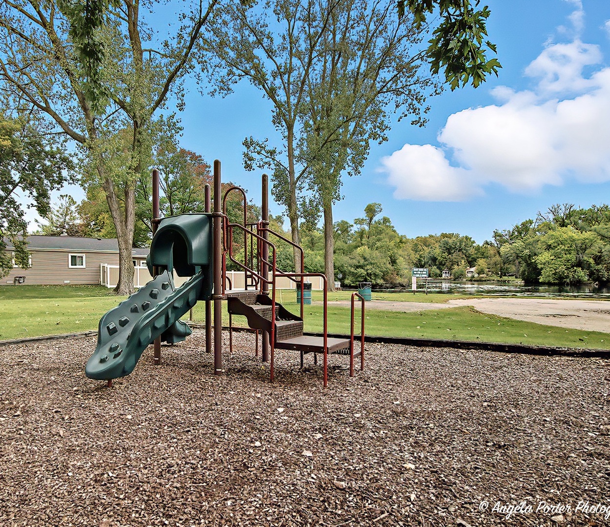 5703 Fox Lake Road McHenry, IL 60051 - Photo 16 of 20 a park view with a bench