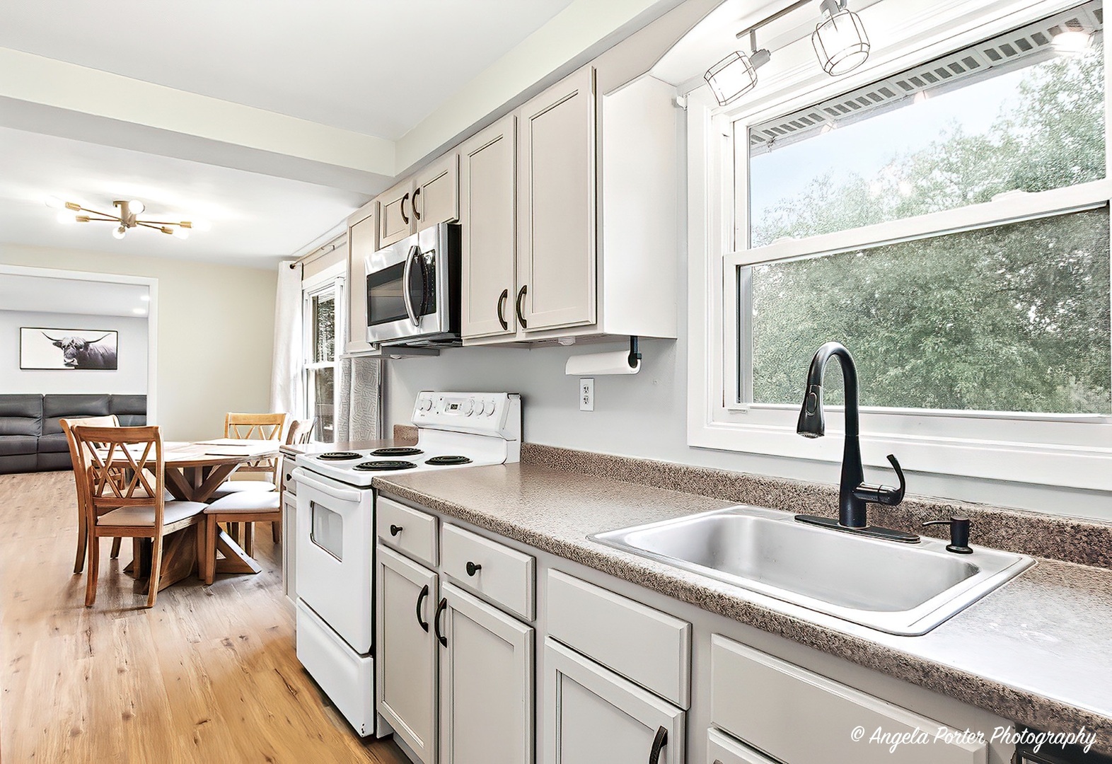 5703 Fox Lake Road McHenry, IL 60051 - Photo 5 of 20 a kitchen with stainless steel appliances granite countertop a sink dishwasher and cabinets with wooden floor