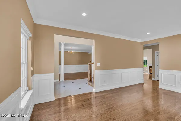 wooden floor in an empty room with a window