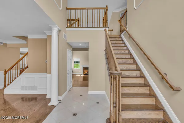a view of entryway and hall with wooden floor