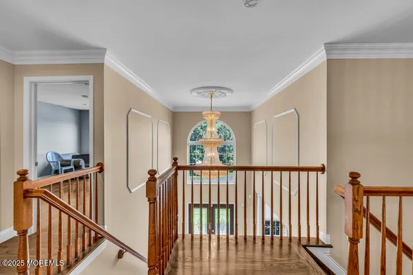 a view of a hallway with furniture and a window