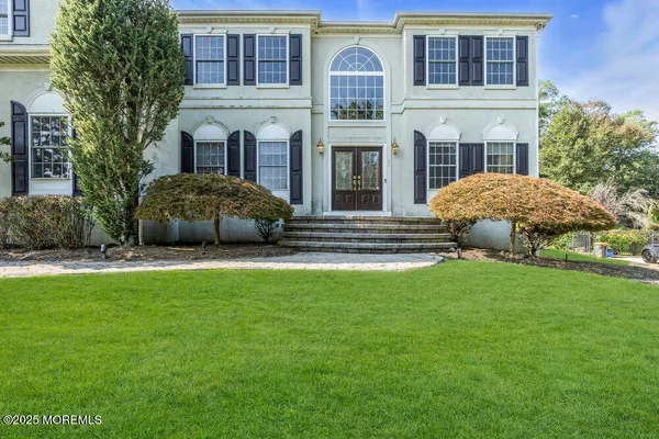 a view of a front of a house with a garden
