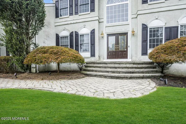 a view of a house with a yard and pathway