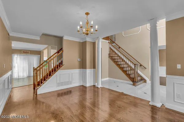 a view of entryway and hall with wooden floor
