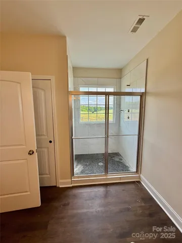 a view of a room with wooden floor and windows