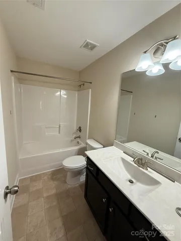 a bathroom with a double vanity sink toilet mirror and bathtub