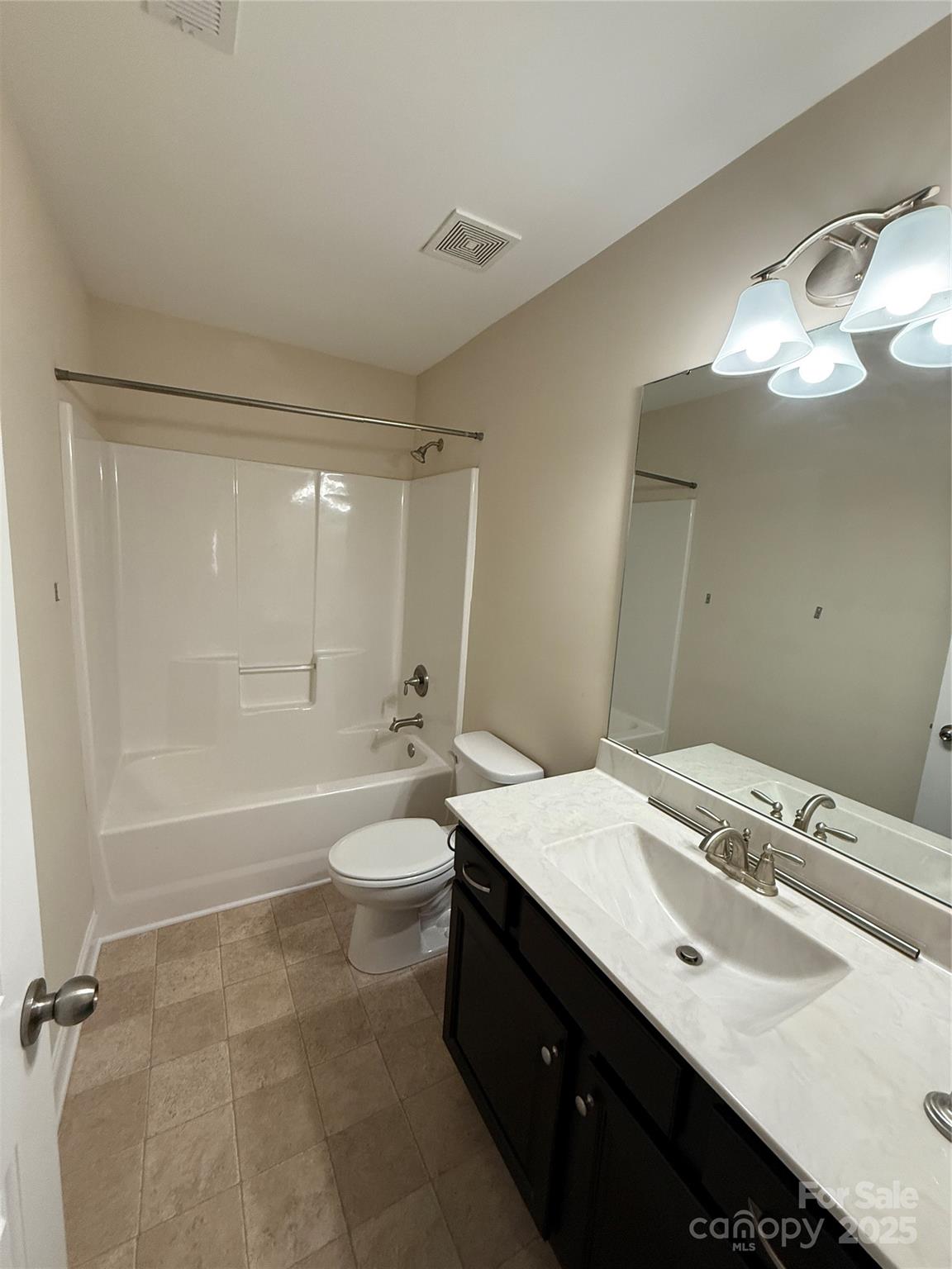 4048 Avis Way Monroe, NC 28110 - Photo 15 of 23 a bathroom with a double vanity sink toilet mirror and bathtub