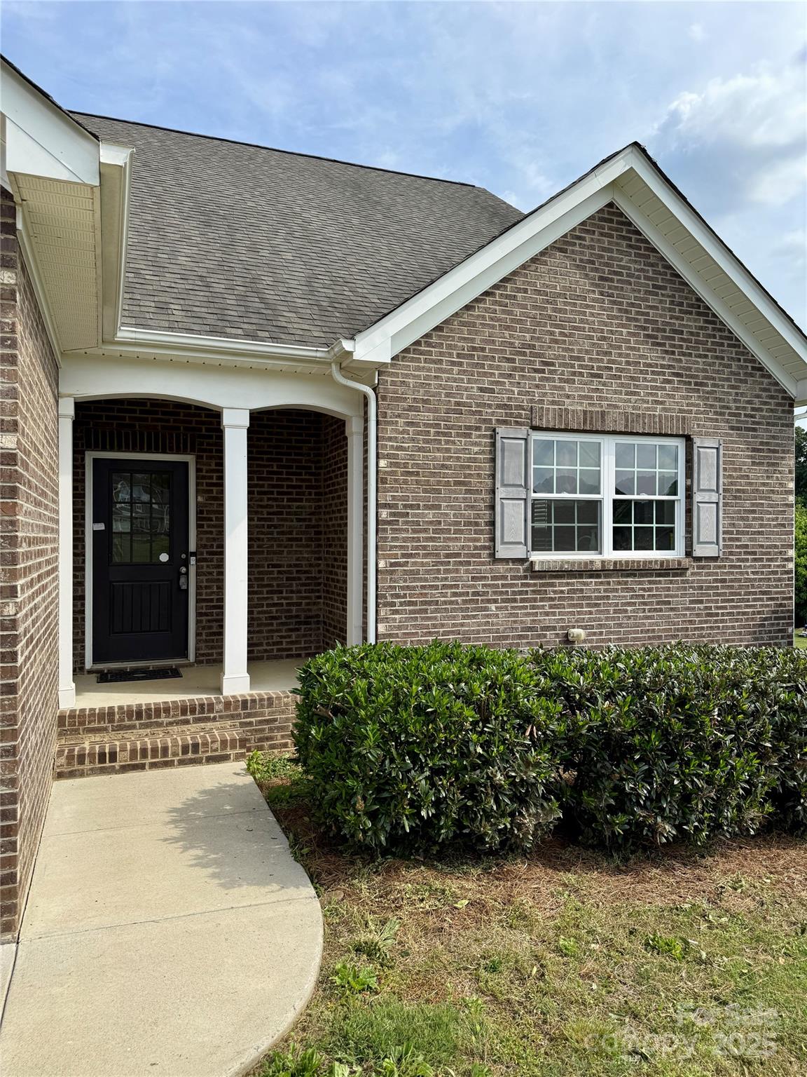 4048 Avis Way Monroe, NC 28110 - Photo 2 of 23 a front view of a house with a garden