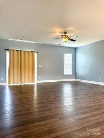 a view of wooden floor and windows in a room