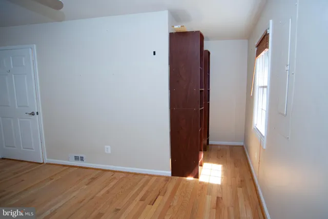 a bathroom with a granite countertop toilet and a sink