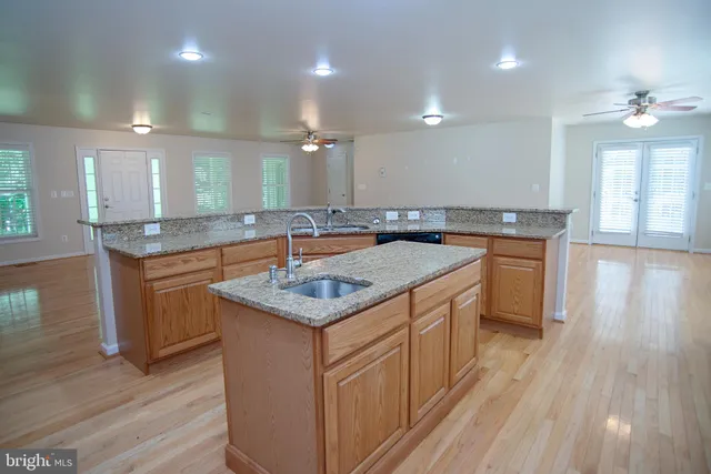 a bathroom with a sink a vanity and a large mirror