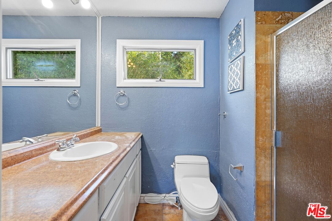 2955 Corral Canyon Road Malibu, CA 90265 - Photo 12 of 21 a bathroom with a sink a toilet and a window