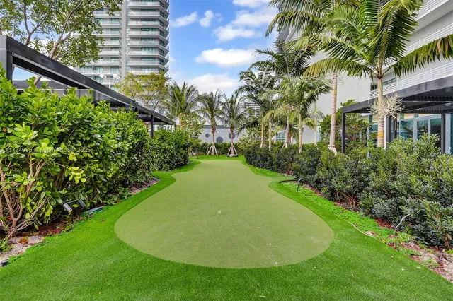 a kitchen with large windows and furniture