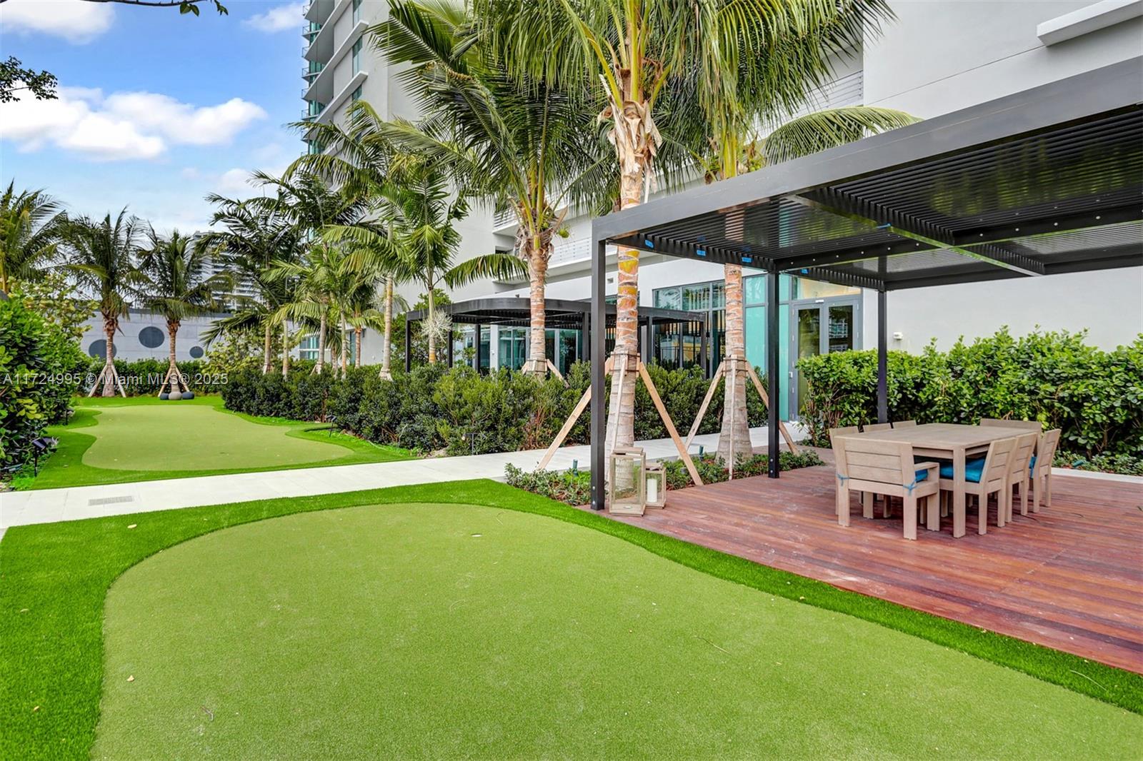650 Northeast 32nd Street, Unit 1008 Miami, FL 33137 - Photo 16 of 57 a view of a house with a backyard patio and slide