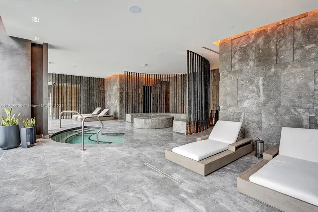 a view of living room with furniture and floor to ceiling window