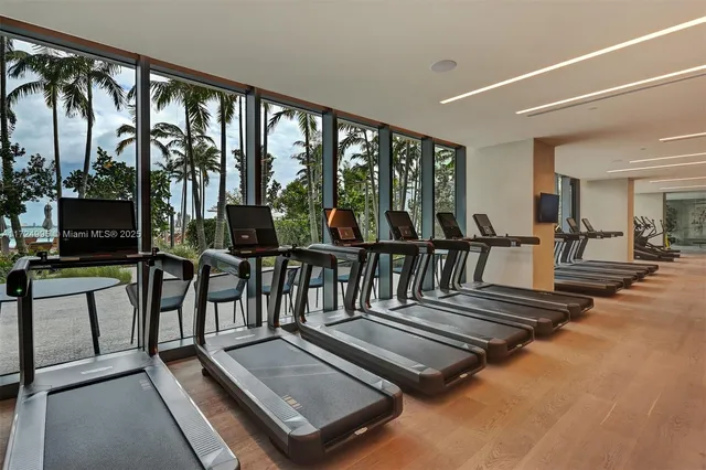 a living room with furniture a window and gym equipment