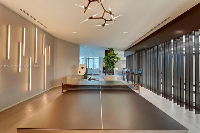 a living room with furniture kitchen view and a large window