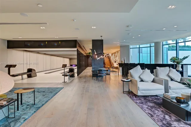 a room with pool table and windows