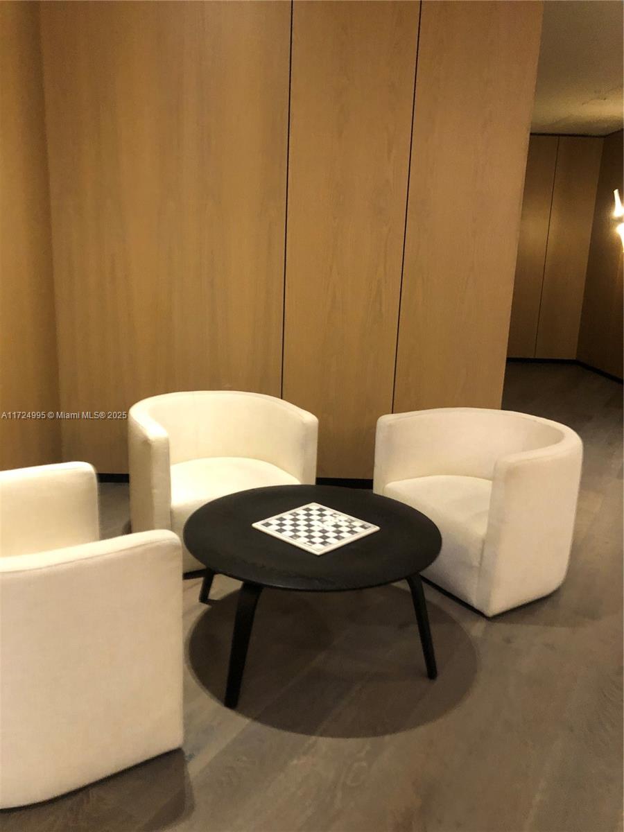 650 Northeast 32nd Street, Unit 1008 Miami, FL 33137 - Photo 50 of 57 a living room with furniture and a lamp