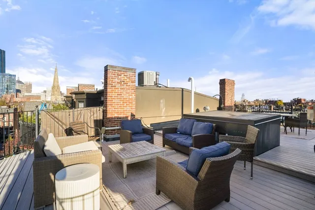 a balcony with furniture and wooden floor