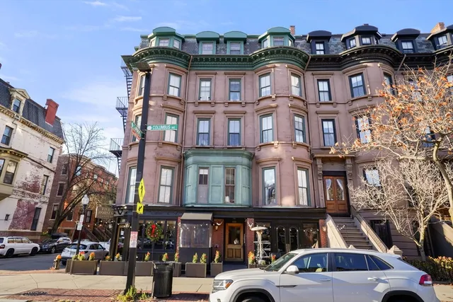 a front view of a residential apartment building with a yard