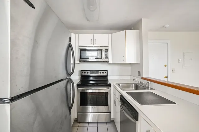 a kitchen with a sink stove and microwave