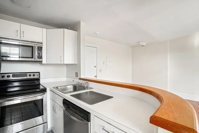 a kitchen with a sink stove and microwave
