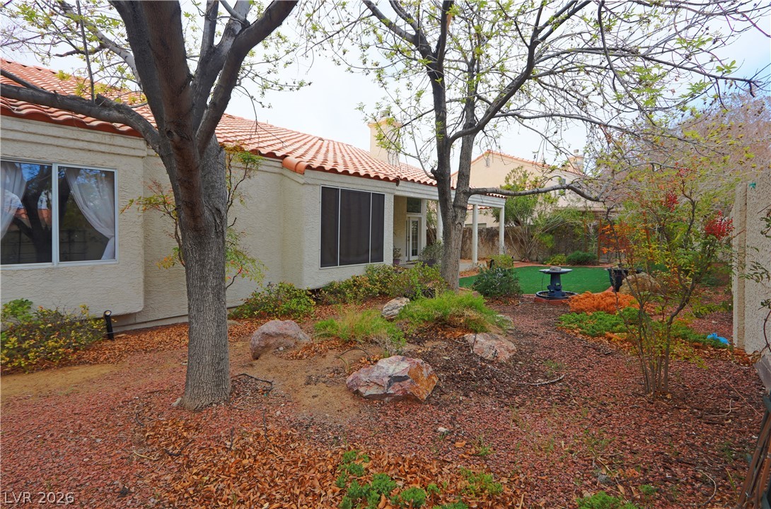 2108 Crestpoint Way Las Vegas, NV 89134 - Photo 24 of 27 A terracotta tile roof accents this home with a gravel yard and lush, green artificial turf.