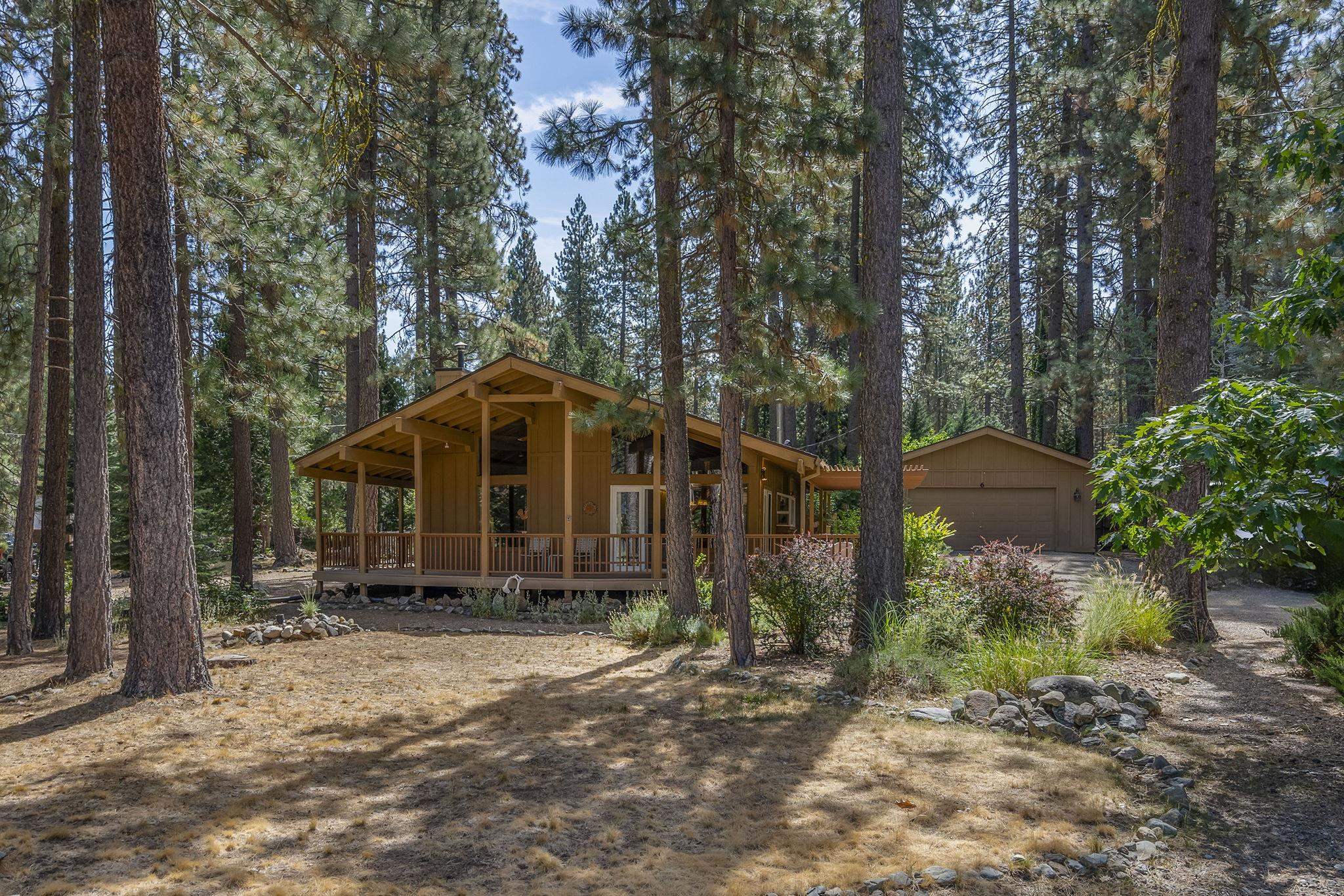 6 Hokan Trail Graeagle, CA 96103 - Photo 1 of 28 a view of a small house with a yard and large trees