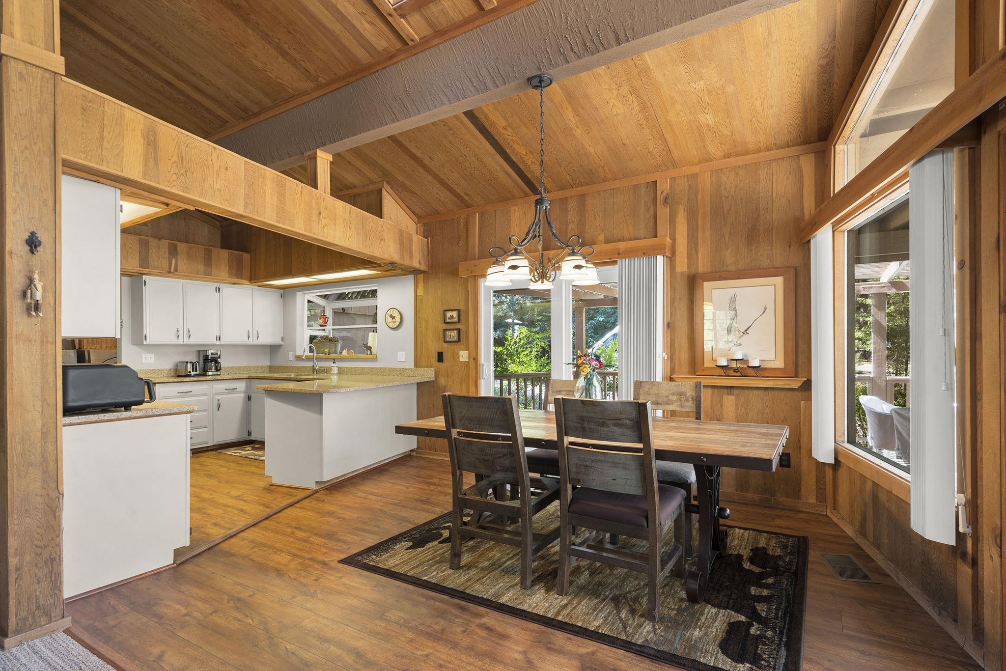 6 Hokan Trail Graeagle, CA 96103 - Photo 11 of 28 a dining room with wooden floor and large windows