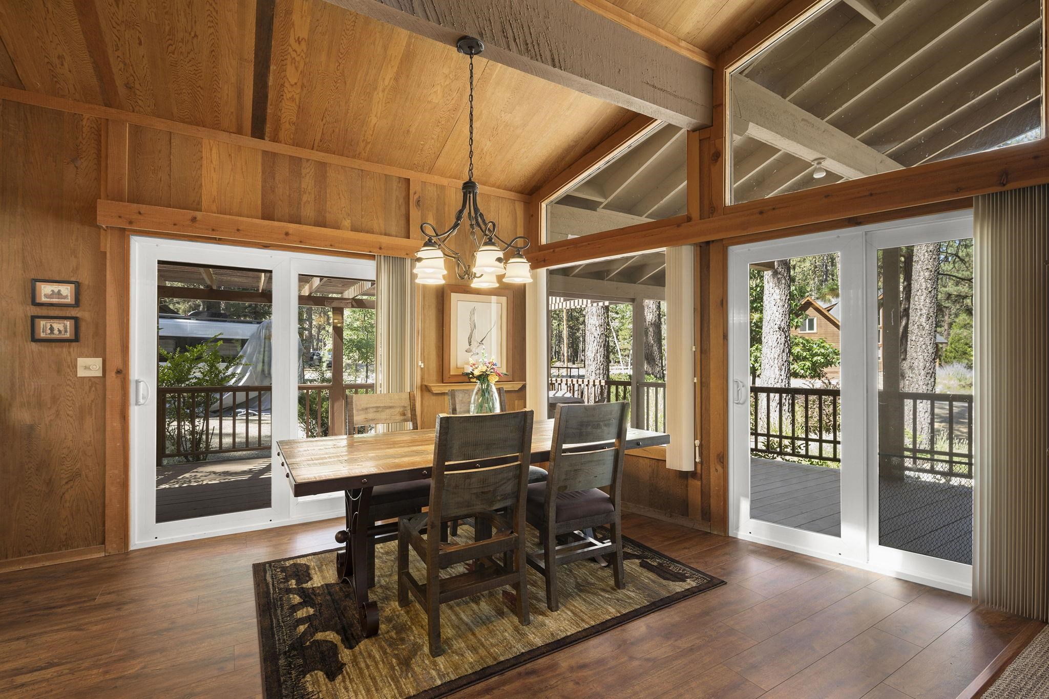 6 Hokan Trail Graeagle, CA 96103 - Photo 12 of 28 a view of a dining room with furniture wooden floor and floor to ceiling window
