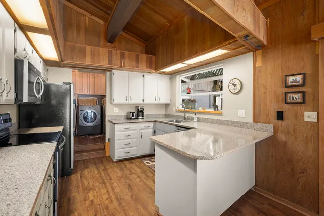 a kitchen with a sink stove and refrigerator