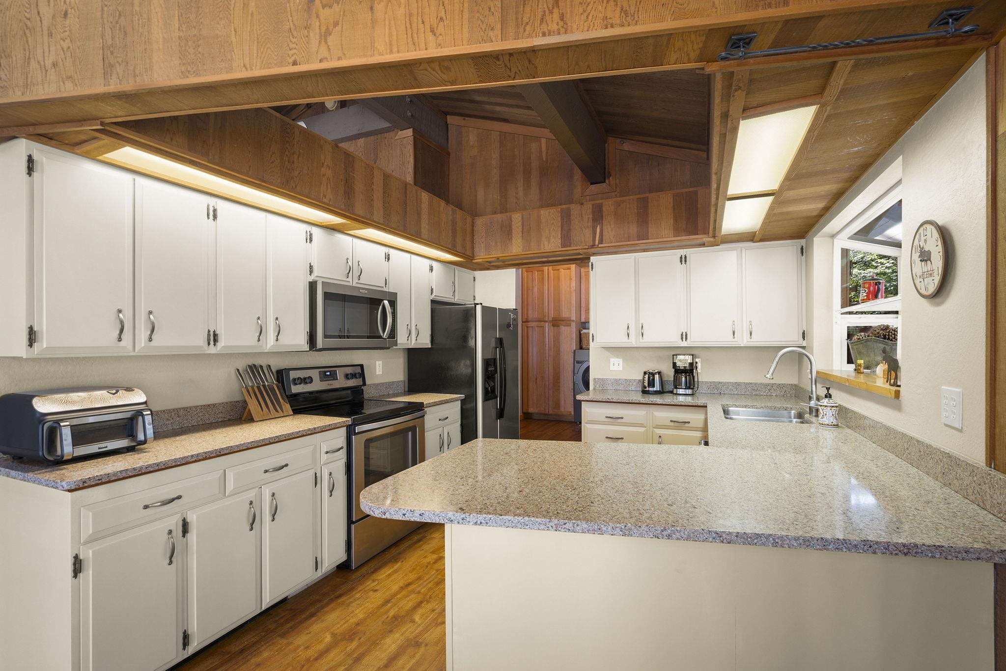 6 Hokan Trail Graeagle, CA 96103 - Photo 15 of 28 a kitchen with stainless steel appliances granite countertop a sink a stove and cabinets