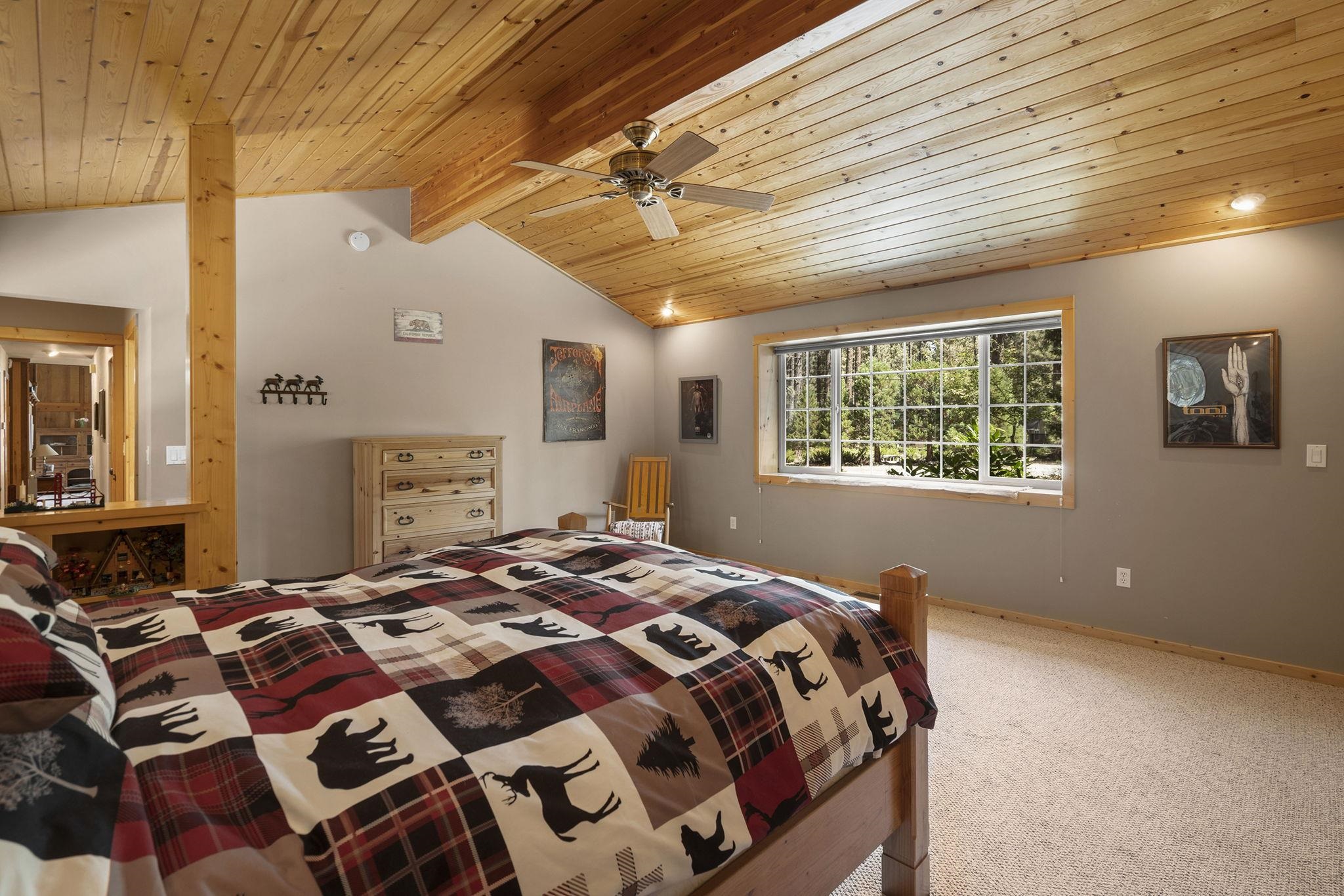 6 Hokan Trail Graeagle, CA 96103 - Photo 18 of 28 a bedroom with a bed and a window