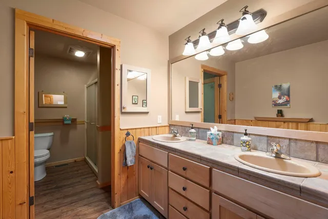 a bathroom with a double vanity sink and a mirror