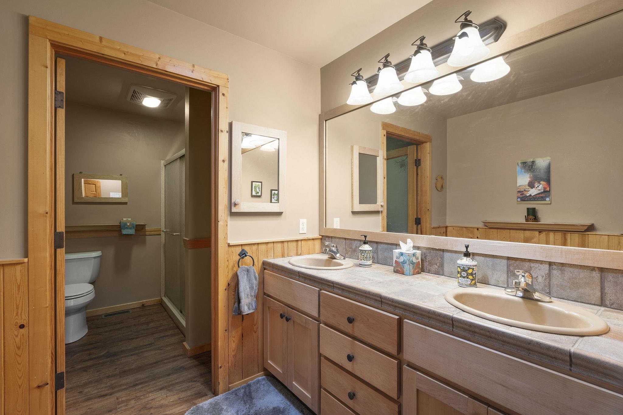 6 Hokan Trail Graeagle, CA 96103 - Photo 19 of 28 a bathroom with a double vanity sink and a mirror