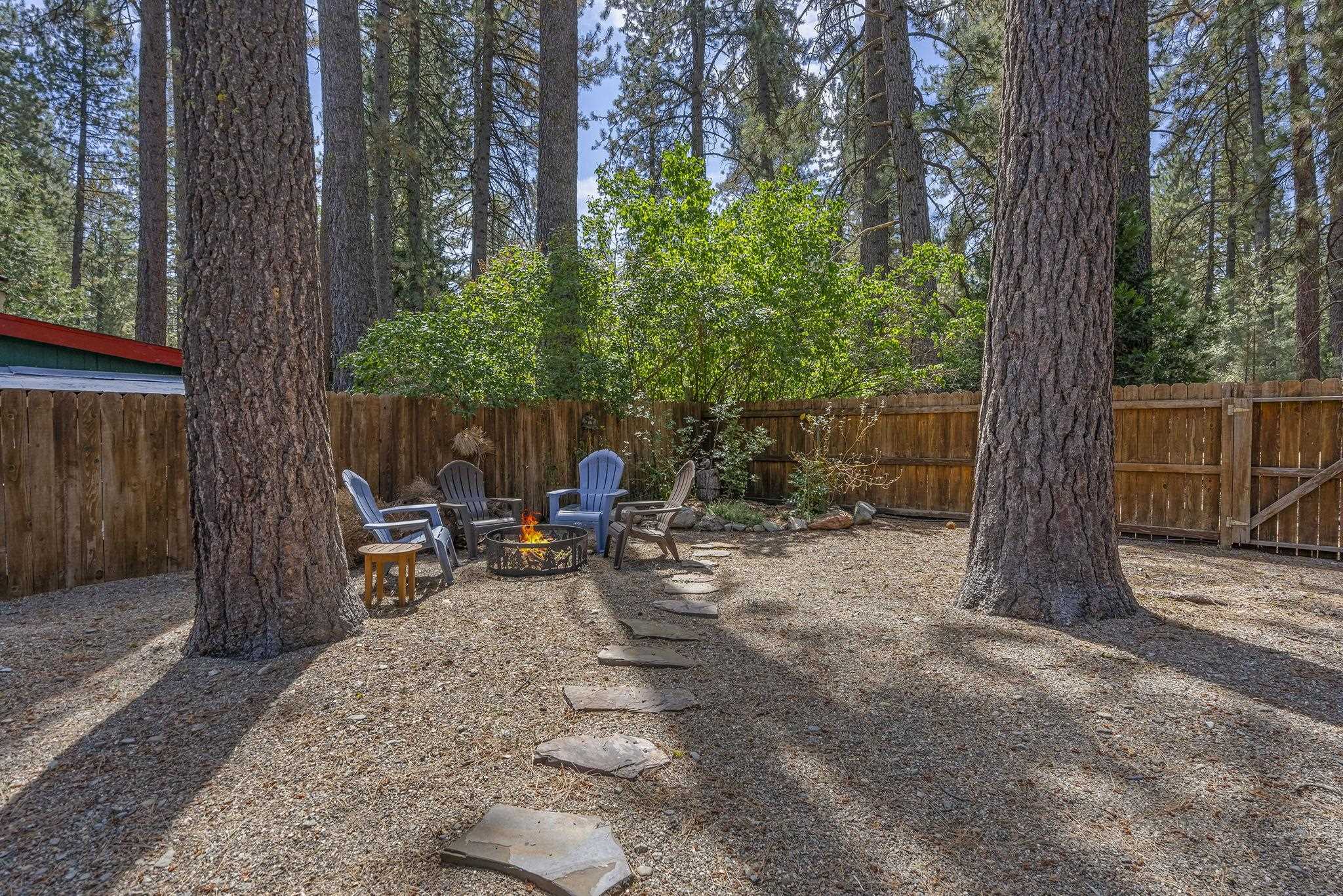 6 Hokan Trail Graeagle, CA 96103 - Photo 24 of 28 a view of backyard with a table and chairs and a large tree