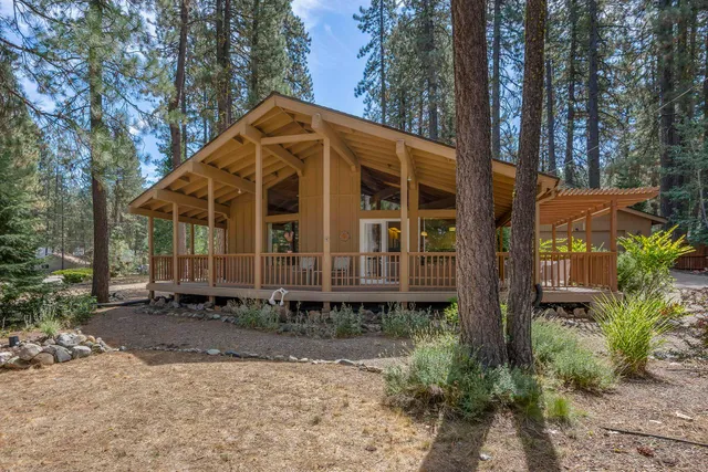 a view of a house with yard and sitting area