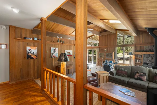 a living room with furniture wooden floor and a large window