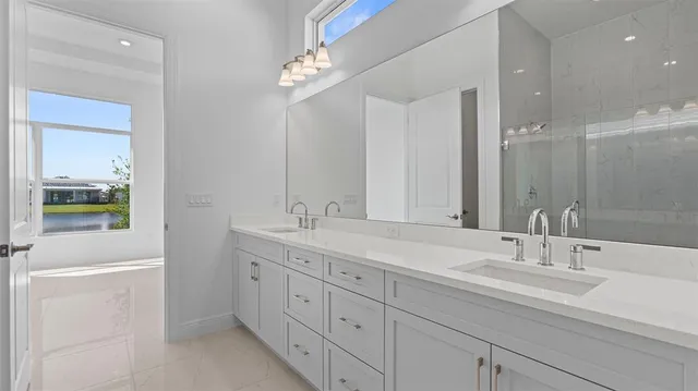 a bathroom with double sink and a mirror