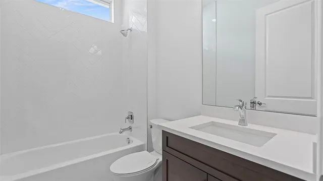 a bathroom with a sink toilet a bathtub and vanity